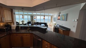 A modern kitchen with a large island, wooden cabinets, and a view of the sea. - Direct Bay Views - Private Balcony Pool Hot Tub (St. Petersburg)