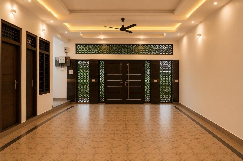 A hallway with a patterned floor, a ceiling fan, and a decorative gate.