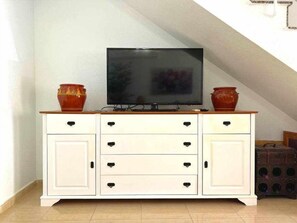 A white cabinet with drawers and a television on top. - Casa Resort Mi Alcazar by Rental Hero (Alcazares, Los)