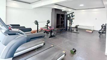 A gym with treadmills, weight machines, and free weights.