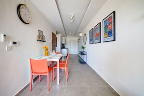 A modern kitchen with white cabinets, a black countertop, and a built-in oven. - Stunning Apartment With Valletta and Harbour Views (Gzira)