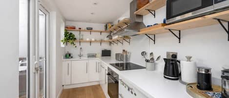 A light, bright, modern kitchen designed for everyday ease. Well equipped with a cafetière, full microwave and oven, plus generous storage to keep surfaces clear. Clean lines and good natural light make it practical, calm, and comfortable to use.
