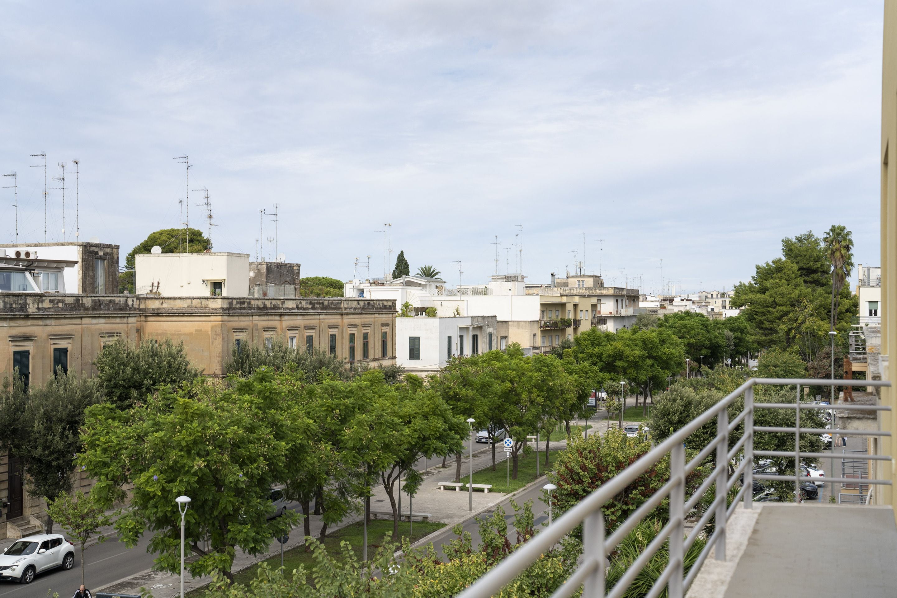 A residential area with buildings, trees, and a street.