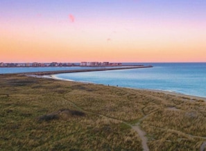 A coastal landscape with a clear sky, a body of water, and a distant shoreline with buildings. - Apartment in Olpenitz With Swimming Pool (Kappeln)