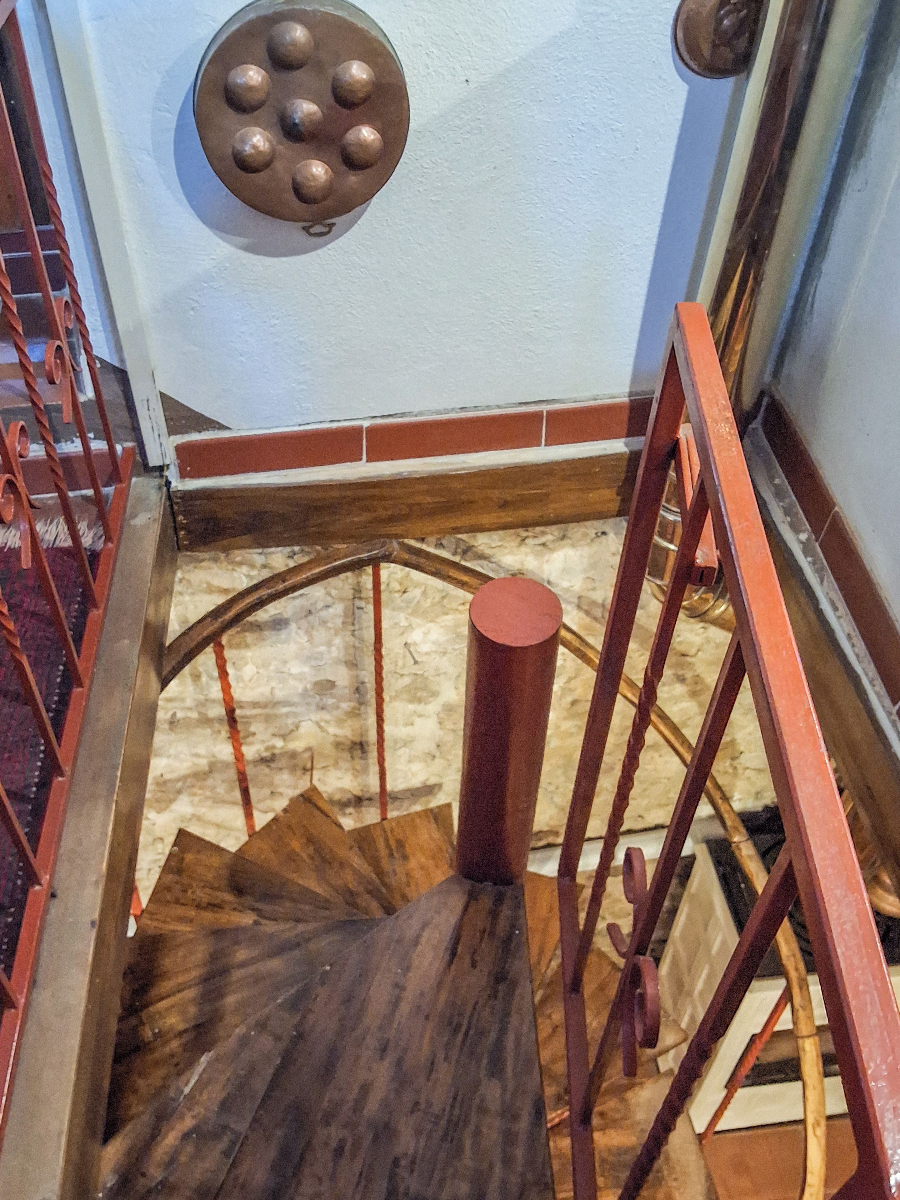A wooden spiral staircase with metal railings.