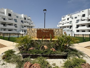 A sign for 'Home Five - Santa Rosa Levansu' with a modern building complex in the background. - Casa Emerald 2 by Rental Hero (Alcazares, Los)