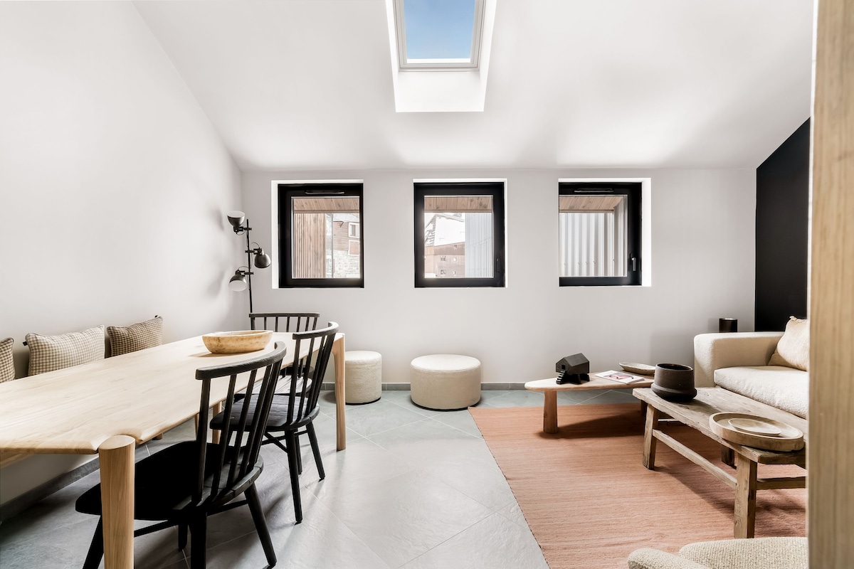 A modern interior with a dining area, a sofa, and a coffee table.