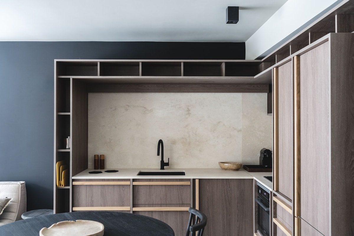 A compact kitchen with a built-in oven, a sink, and a countertop.