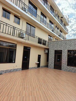 Un edificio de varios pisos con recepción, mostrador de recepción y un baño con lavamanos.