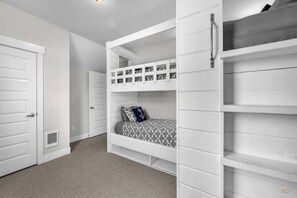 A bunk bed room with white walls, a door, and a vent. - Spacious Olivia Beach Home: Hot Tub, Pool, Games & Pet Friendly! Sleep 10 (Lincoln City)