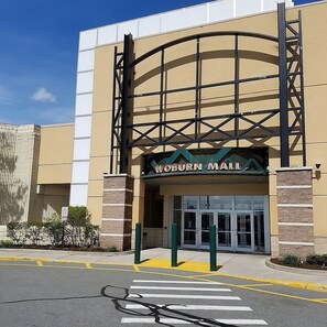 A building with a sign reading "Valburn Mall" and a large entrance with glass doors. - 3 Superior King Units | Free Parking | Pets Are Allowed (Woburn)