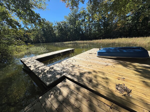 A wooden dock extending into a calm body of water, surrounded by dense trees. - 3-bedroom house in beautiful Lake Norman of Catawba with AC (Lake Norman of Catawba)