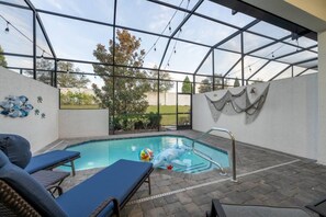 An outdoor swimming pool with lounge chairs, a hot tub, and a pergola structure. - 4BR Getaway | Private Pool & Family Fun (Davenport)