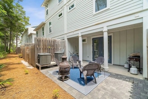 A residential property with a covered patio, outdoor seating, and a fenced yard. - 30A Upscale Villa | Coastal Charm & Beach Access (Santa Rosa Beach)