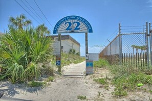 A beach access sign with the number 22, a pathway leading to the beach, and a chain-link fence. - 6BR Panama City Beach Side Oasis | Jacuzzi | Pool (Panama City Beach)