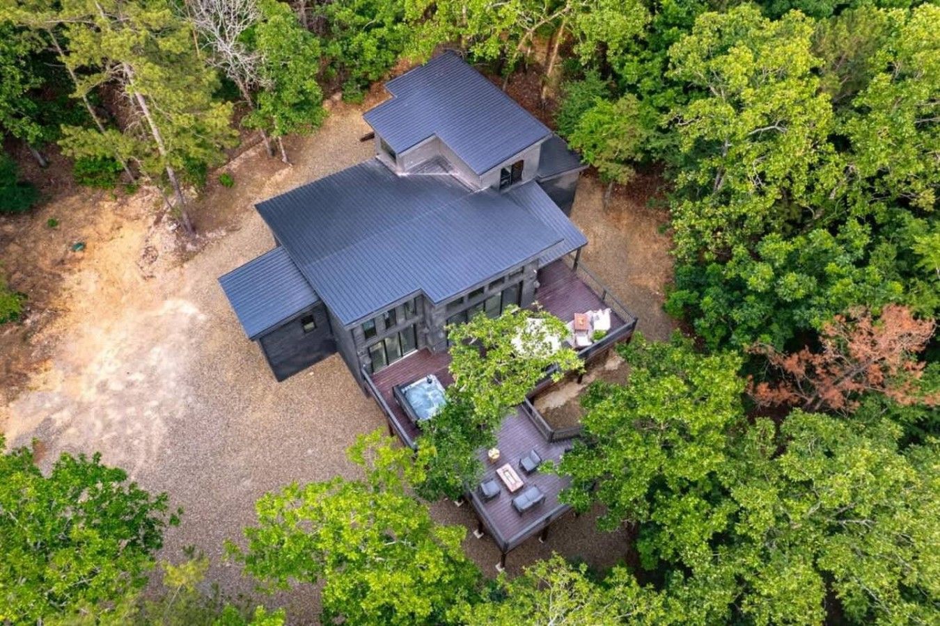 A two-story house with a deck and a patio area.