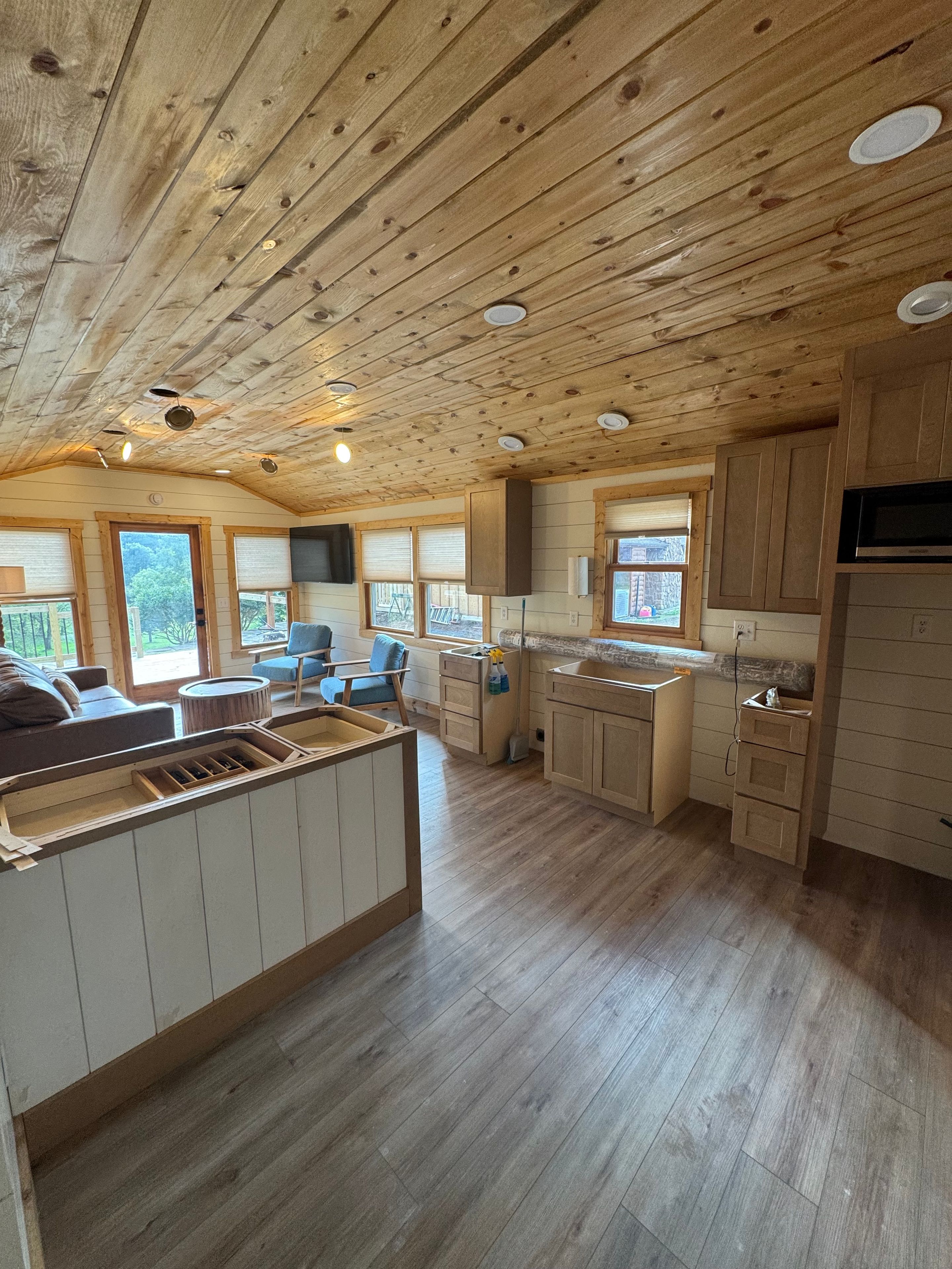 Bright open living area with rustic wood ceilings and cozy cabin charm
