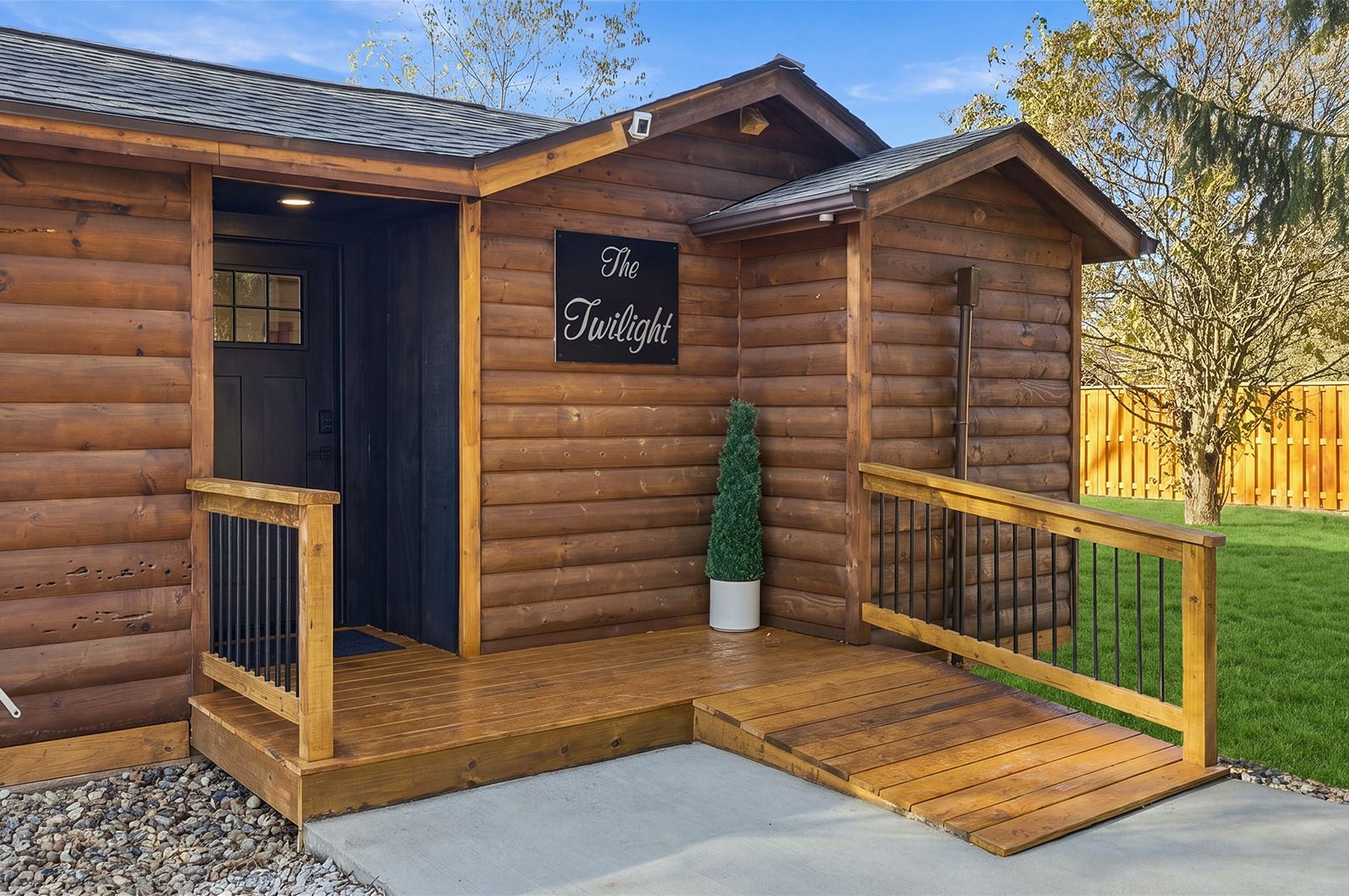 Charming log cabin entry with covered porch and easy-access ramp