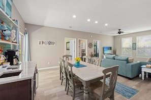 A modern living space with a dining area, kitchen, and seating area. - Your Perfect Beach Getaway | Destin Coastal Home (Destin)