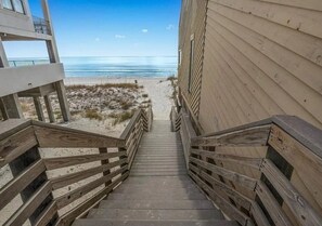 A wooden staircase leading to a beach area with a view of the ocean. - Destin Family Retreat | Private Pool + Beach (Destin)