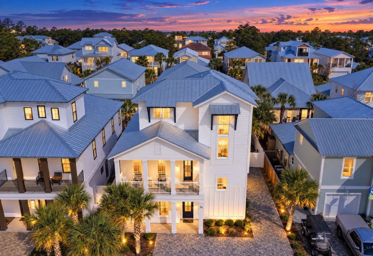 A residential area with multiple houses, each featuring a balcony and a garage.