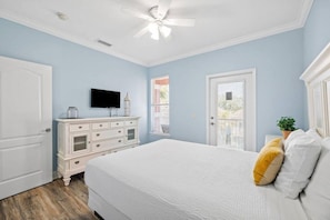 A bedroom with a bed, dresser, television, and a ceiling fan. - 6BR Beach Retreat | 5-Min Walk + Resort Pool (Destin)