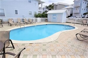 A swimming pool with a tiled deck, surrounded by lounge chairs and a small shed. - 4BR Santa Rosa Beach & Lake Getaway (Santa Rosa Beach)