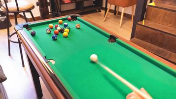 A pool table with balls in a casual indoor setting.
