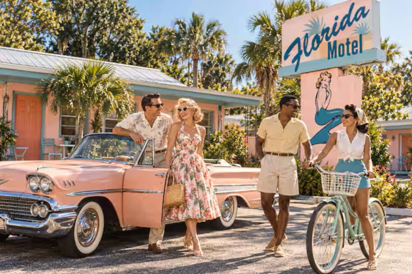 A vintage car parked in front of a motel with a sign that reads 'Florida Motel.'