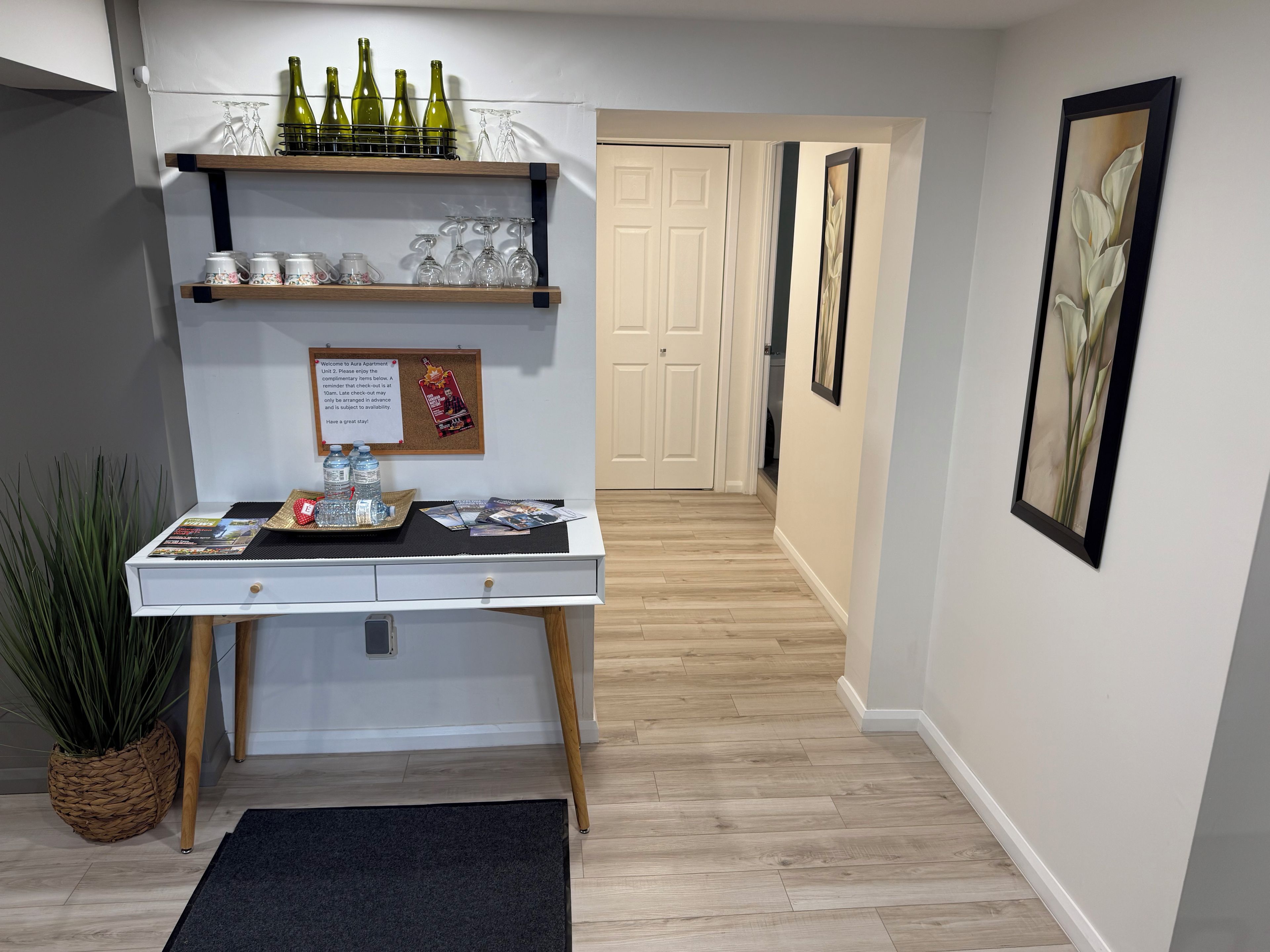 A reception desk with a corkboard, a bulletin board, and a tray of bottled water.