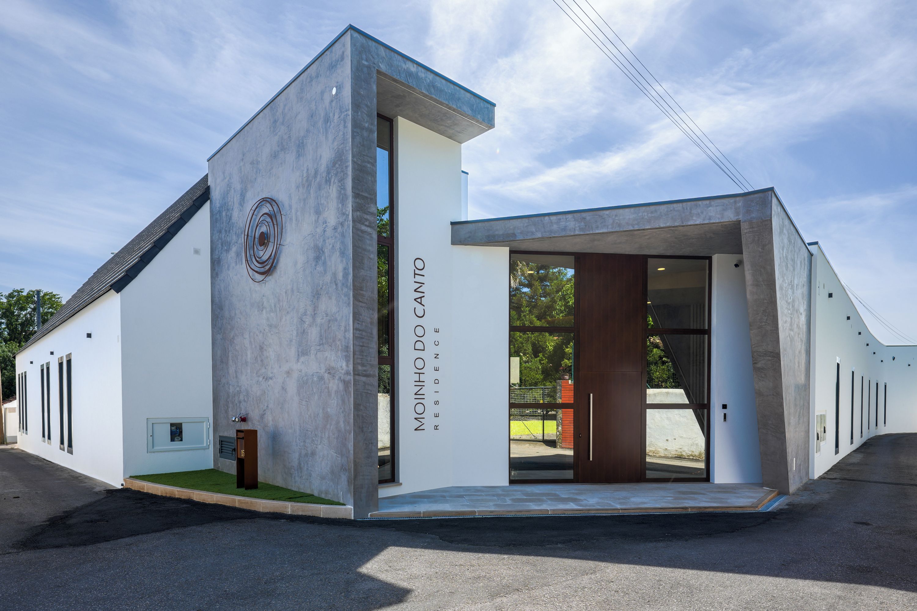 A modern building with a unique architectural design, featuring a prominent entrance and a clear view of the surrounding area.