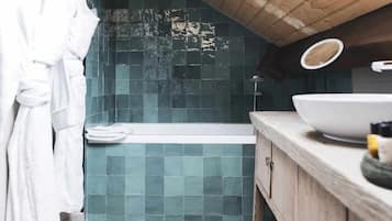 A bathroom with a bathtub, a sink, and a shower.