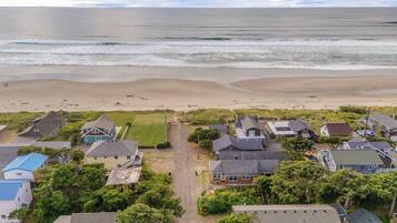 Un quartier résidentiel situé sur la côte, avec des maisons, une plage et une vue sur l’océan.