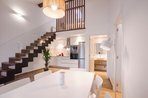 A modern kitchen with a built-in oven, a refrigerator, and a microwave. - TWO-BEDROOM APARTMENT (castroverde)