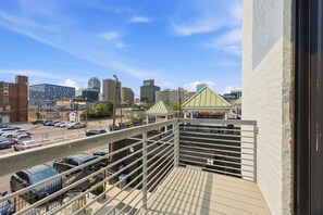 A balcony with a view of a parking lot and city buildings. - Lux Executive Suite: Sleeps 4; Heart of Columbus (Columbus)