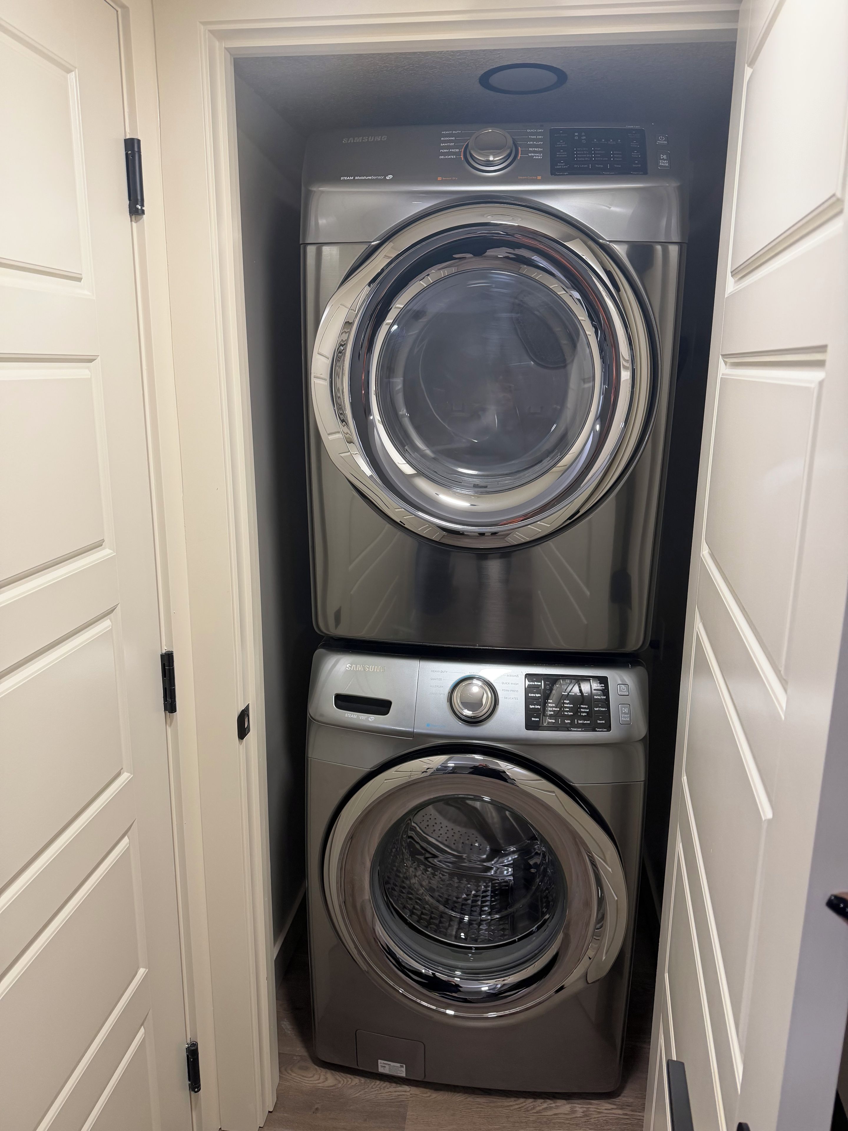 A laundry room with two stacked front-loading washing machines.