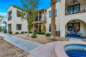 A multi-story residential building with balconies, a swimming pool, and a patio area. - Villa Solana B | Studio Legacy Villa (La Quinta)