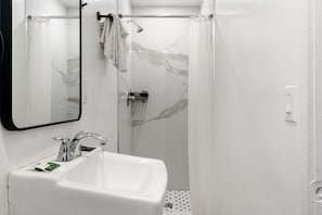 A bathroom with a white sink, a mirror, a shower with a glass door, and a towel rack. - Cozy Queen Bed Retreat, Inglewood Getaway (Inglewood)