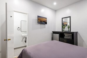 A bedroom with a bed, a bathroom with a sink, a television, and a mirror. - Cozy Queen Bed Retreat, Inglewood Getaway (Inglewood)