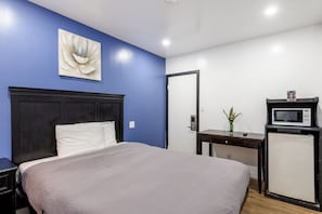 A bedroom with a bed, a desk with a microwave, and a door. - Cozy Queen Bed Retreat, Inglewood Getaway (Inglewood)