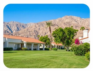 A hotel with a courtyard, white buildings, and a mountain backdrop. - La Quinta Resort Hideaway (La Quinta)