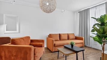 A modern living room with a sofa, armchair, and a coffee table.