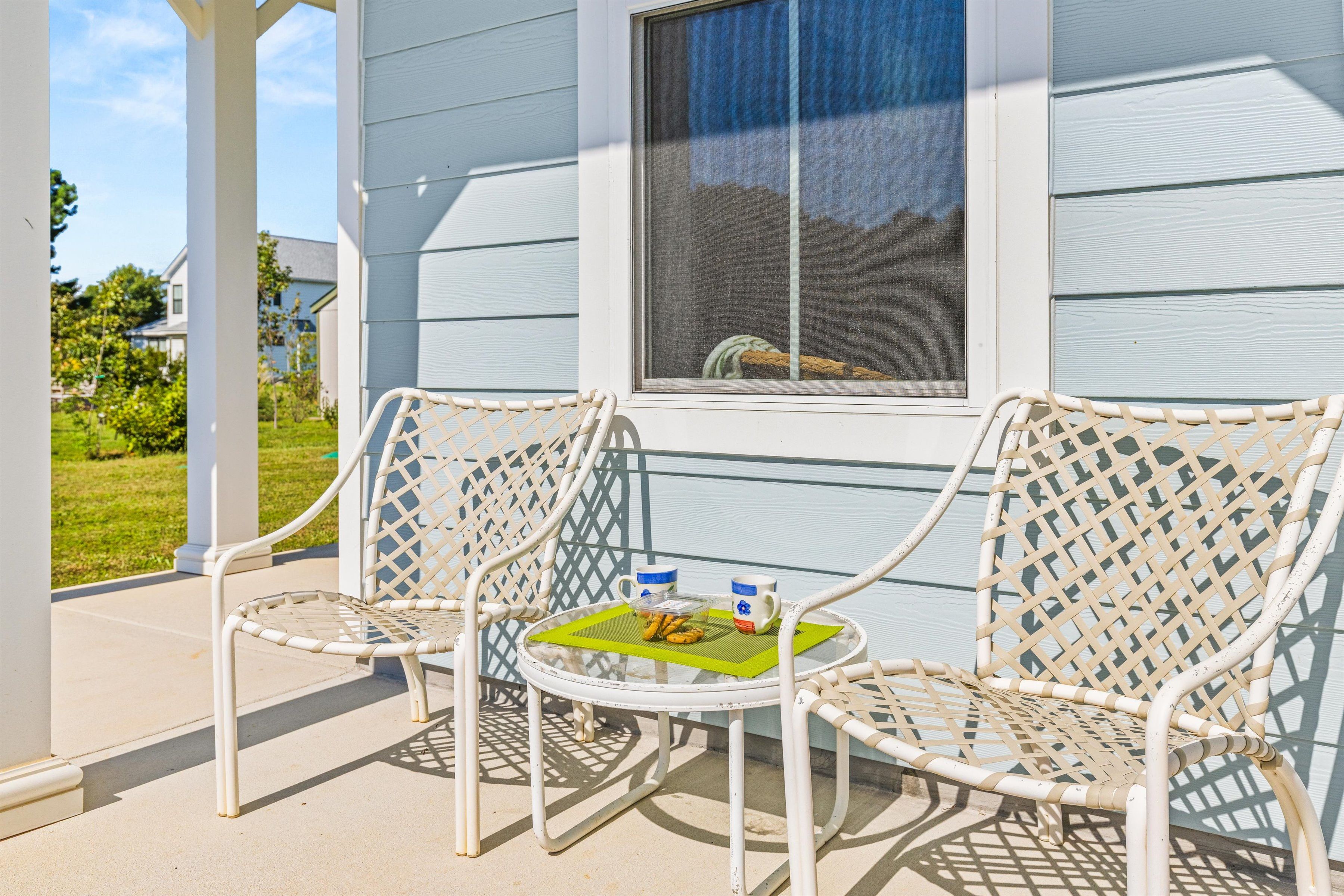 Sunny front porch with cozy seating for morning coffee and fresh air