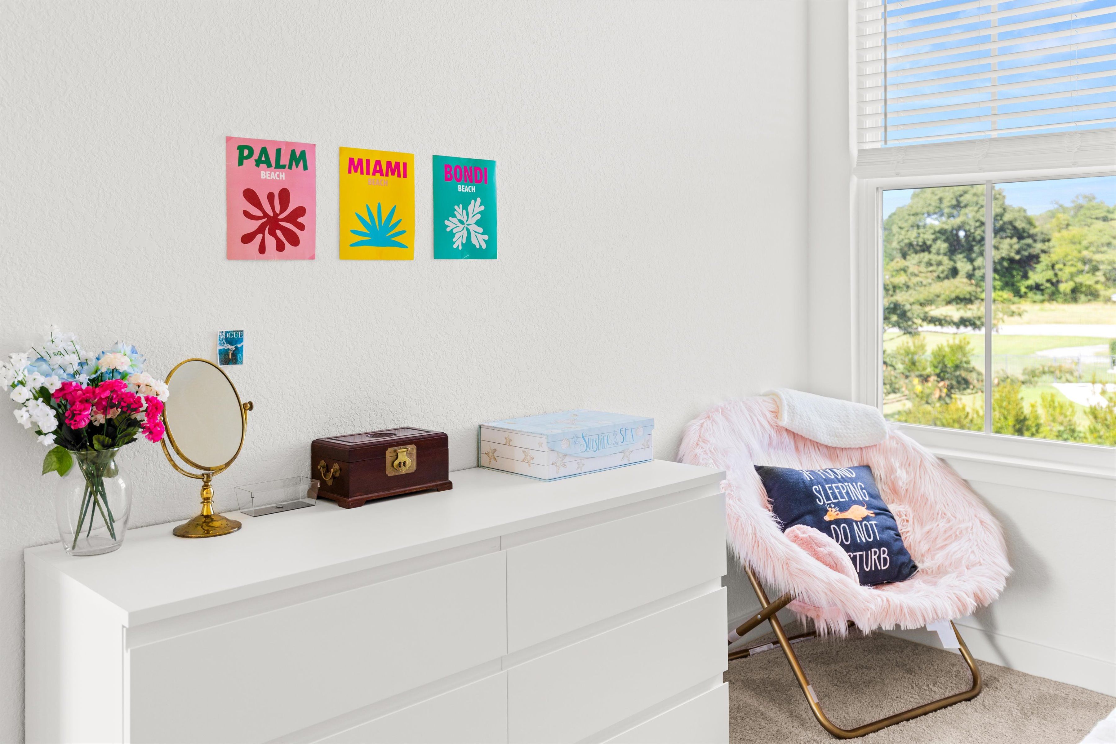 Bright, stylish bedroom nook with natural light and a cozy chair