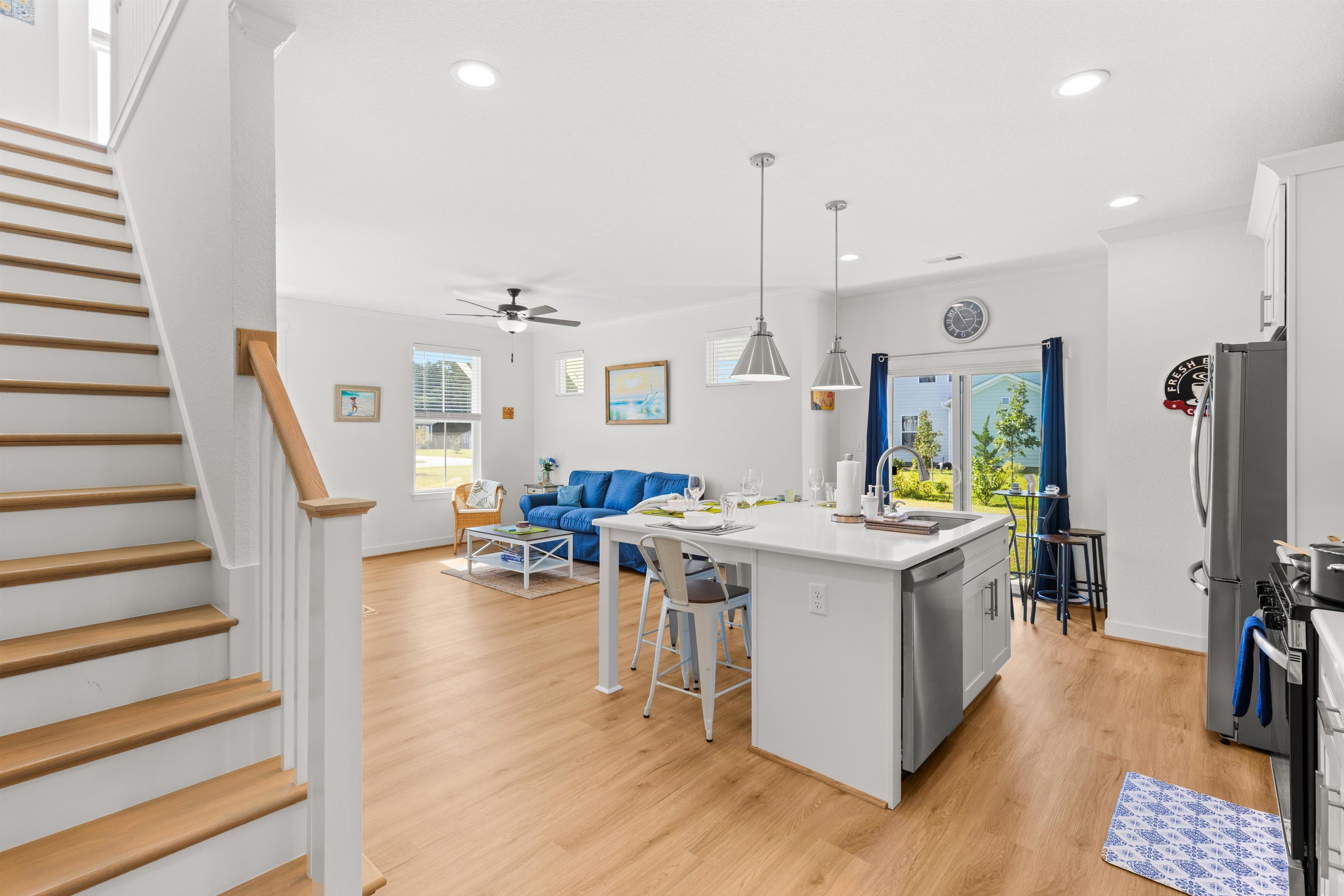 Bright open living space with modern kitchen island and cozy lounge