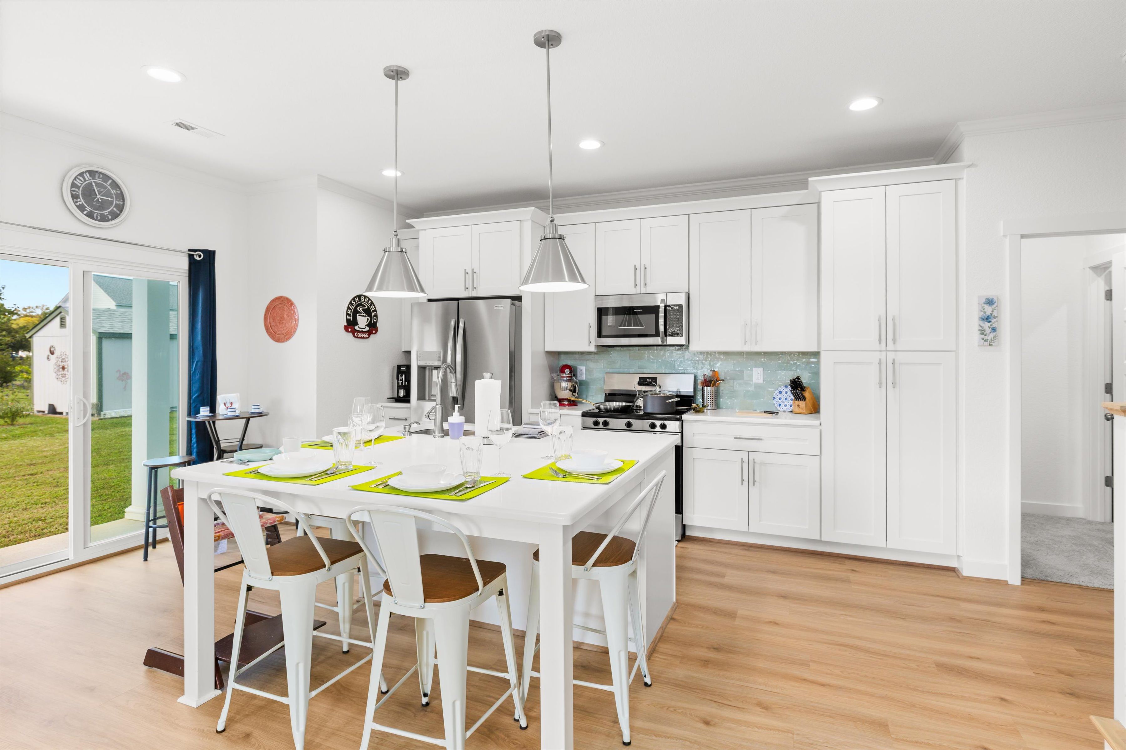 Bright modern kitchen with island dining for 6 and outdoor access