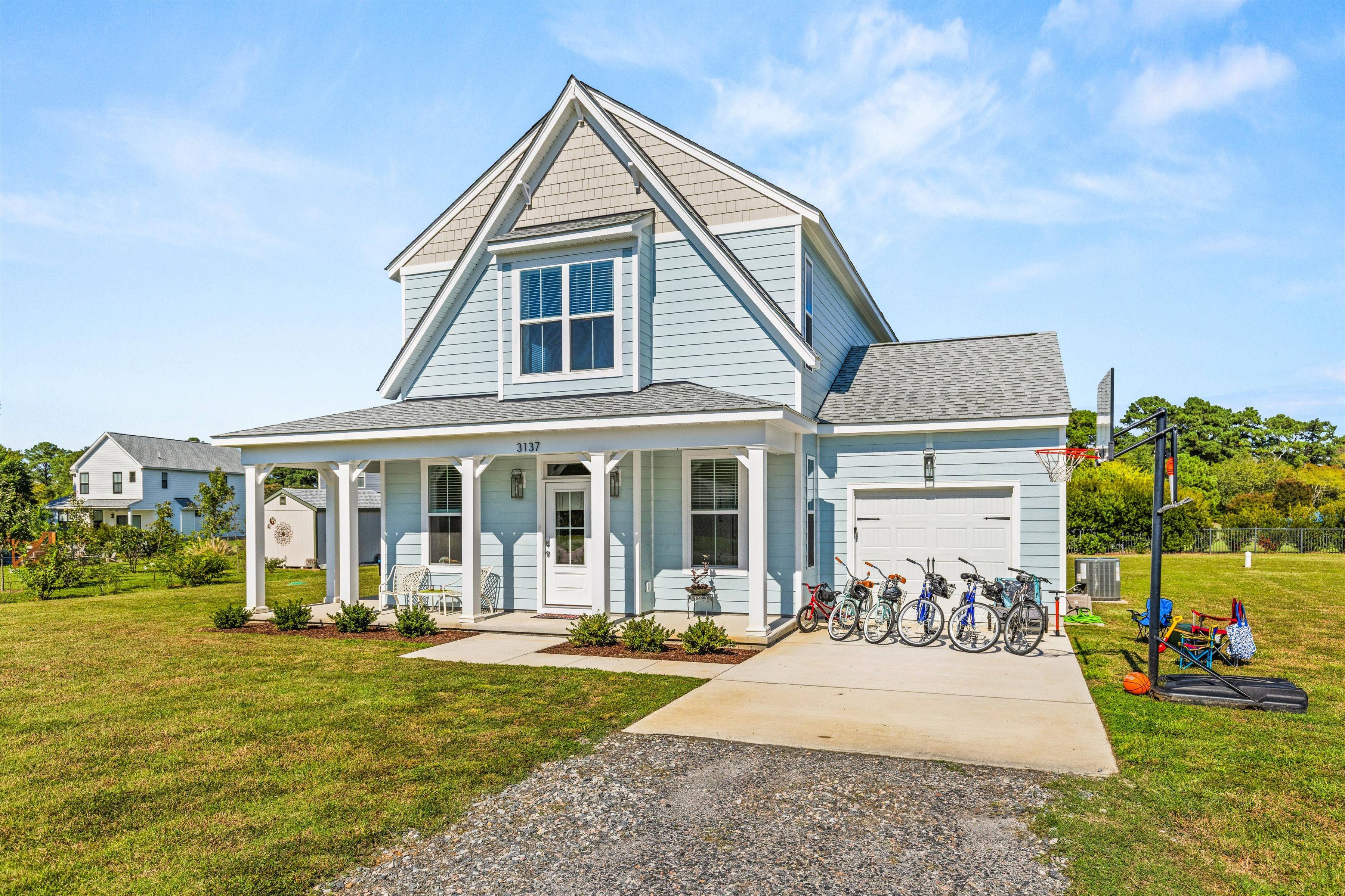 Charming coastal home with porch, bikes, garage, and family-friendly yard