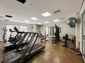 A gym with treadmills, weight machines, and a mirrored wall. - 1BR Apt With Pool Gym in Downtown Rio - Rz513 (Rio de Janeiro)