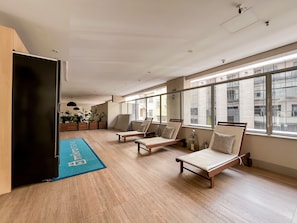 A spacious room with a large window, a blue mat with text, and two wooden chairs. - 1BR Apt With Pool Gym in Downtown Rio - Rz513 (Rio de Janeiro)
