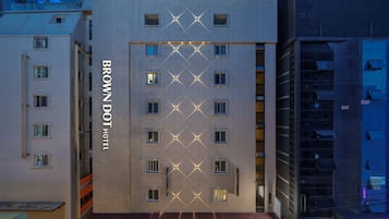 A multi-story hotel with a prominent 'BROWN DOT HOTEL' sign on the facade.